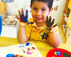 Child doing hand painting